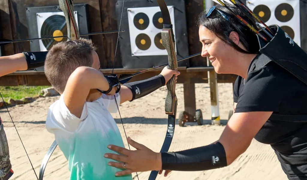 a young boy at an archery lesson