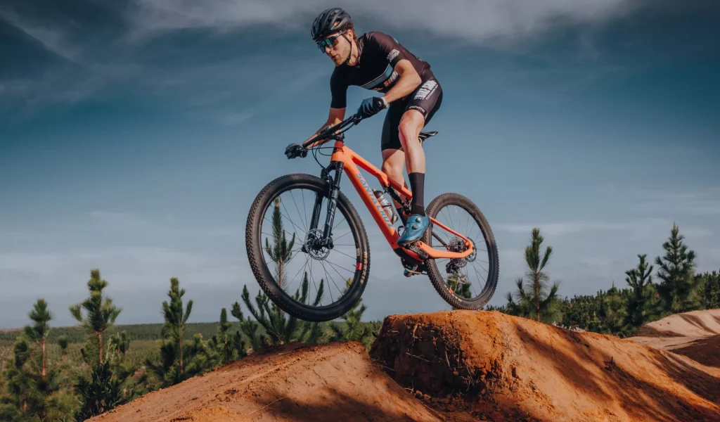 a mountain biker ramping in the outdoors