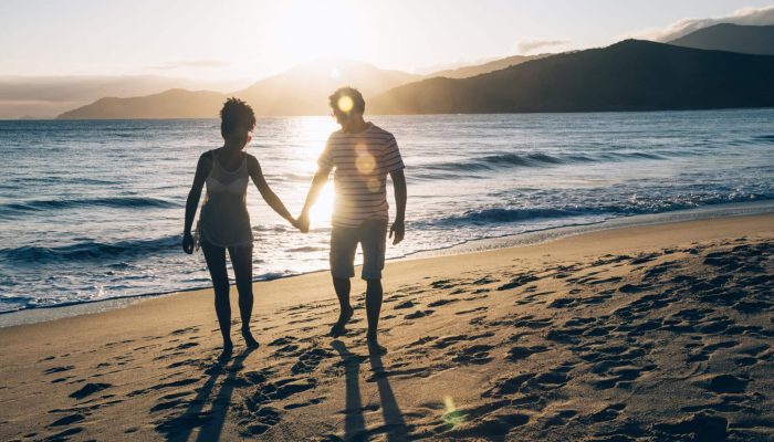 couple-couple-holding-hands-beach-sunset